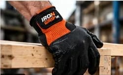 Gloved hand holding a length of timber